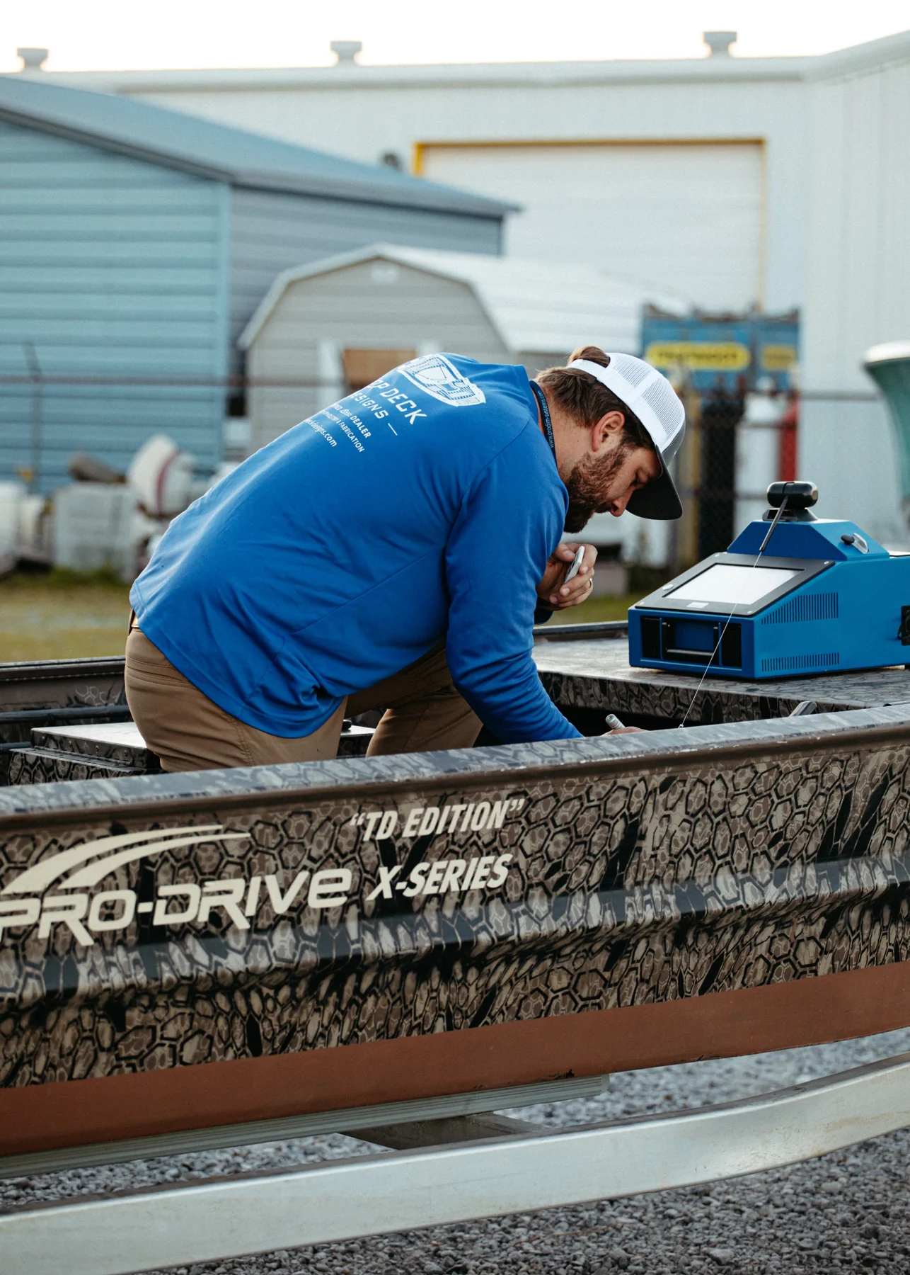 Hands-on fitting work on a camouflage Pro-Drive boat.