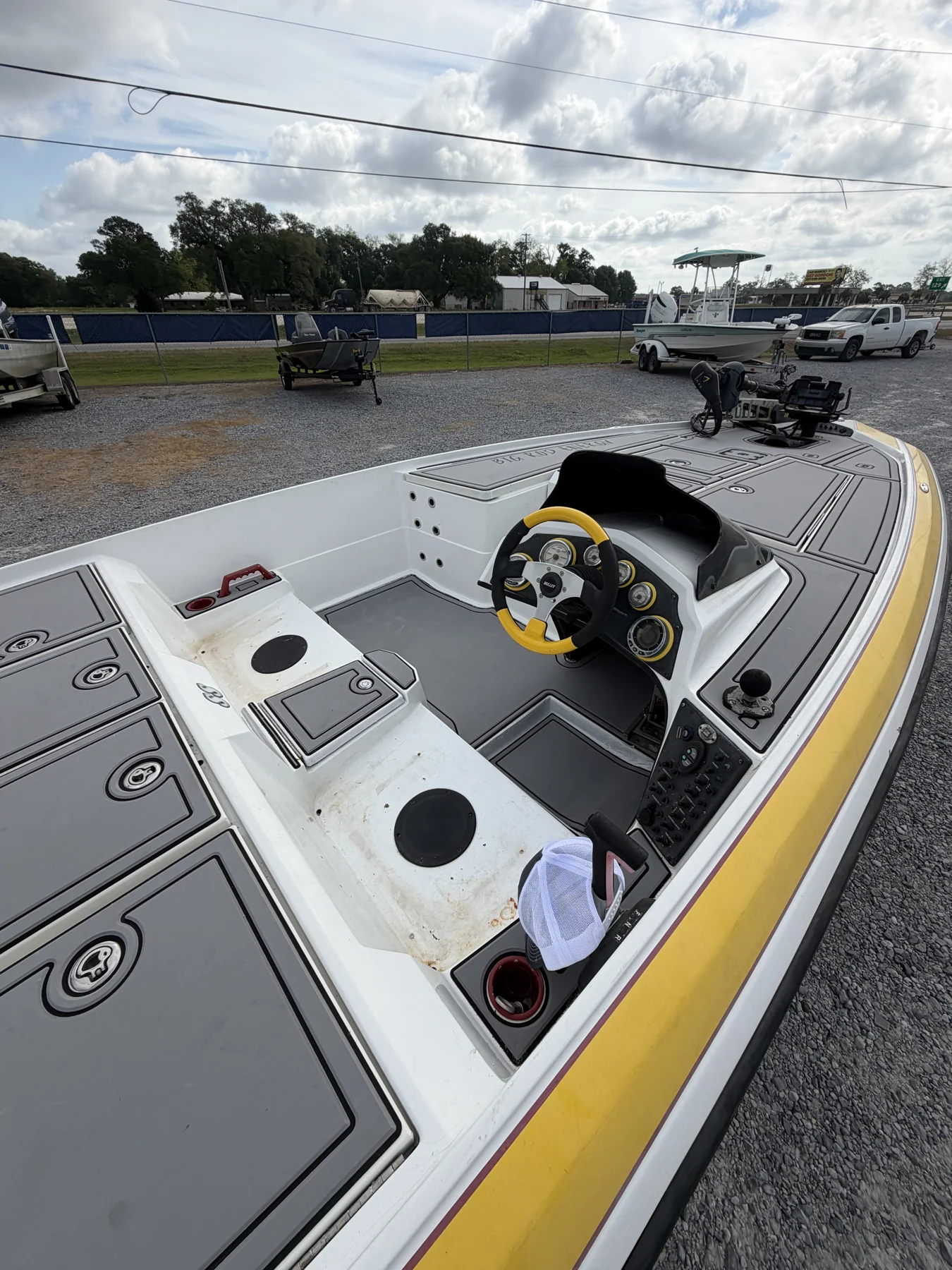 Gray casting deck and cockpit flooring on a yellow fishing boat.