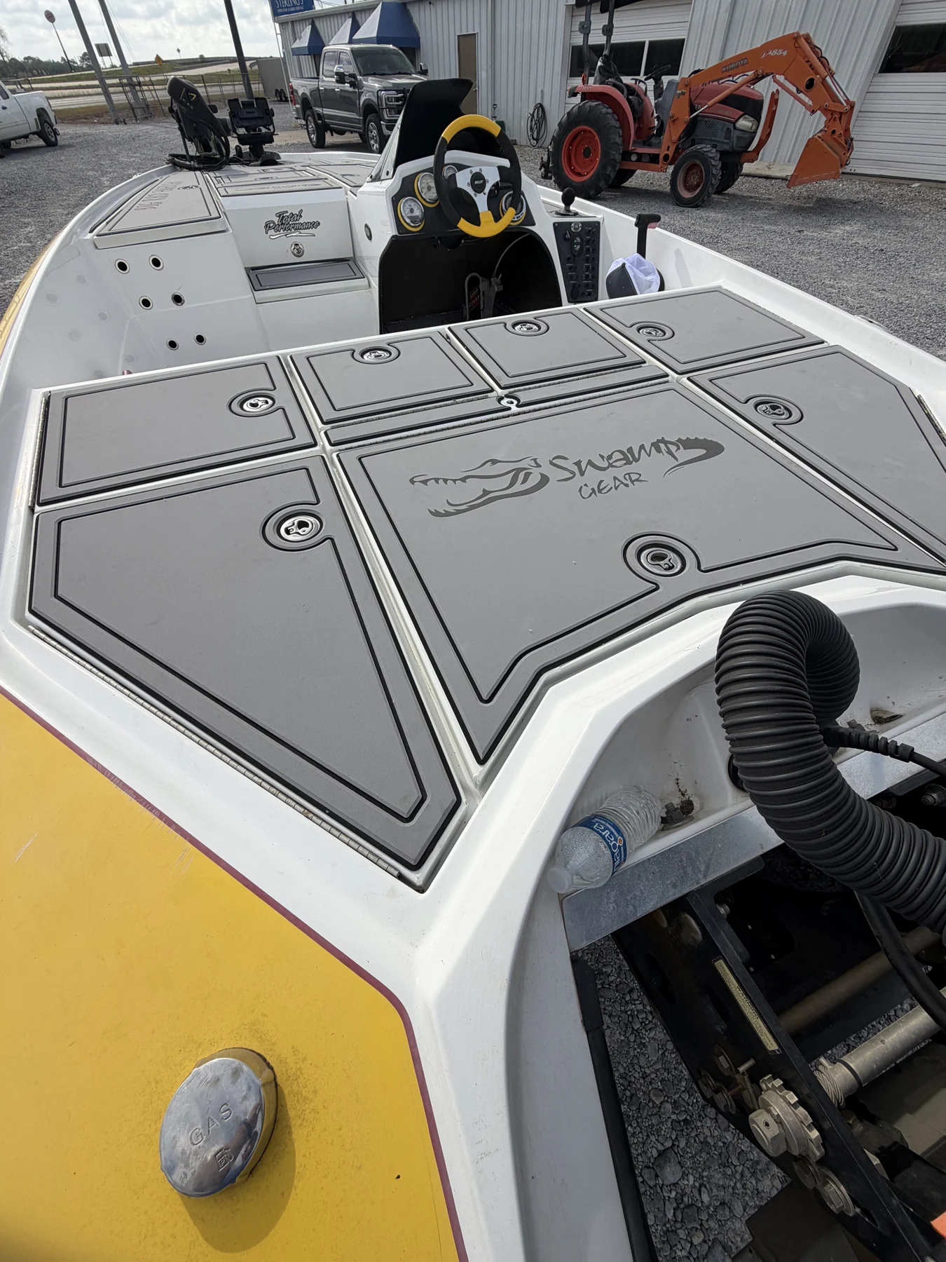 Gray patterned bow panels on a yellow fishing boat.