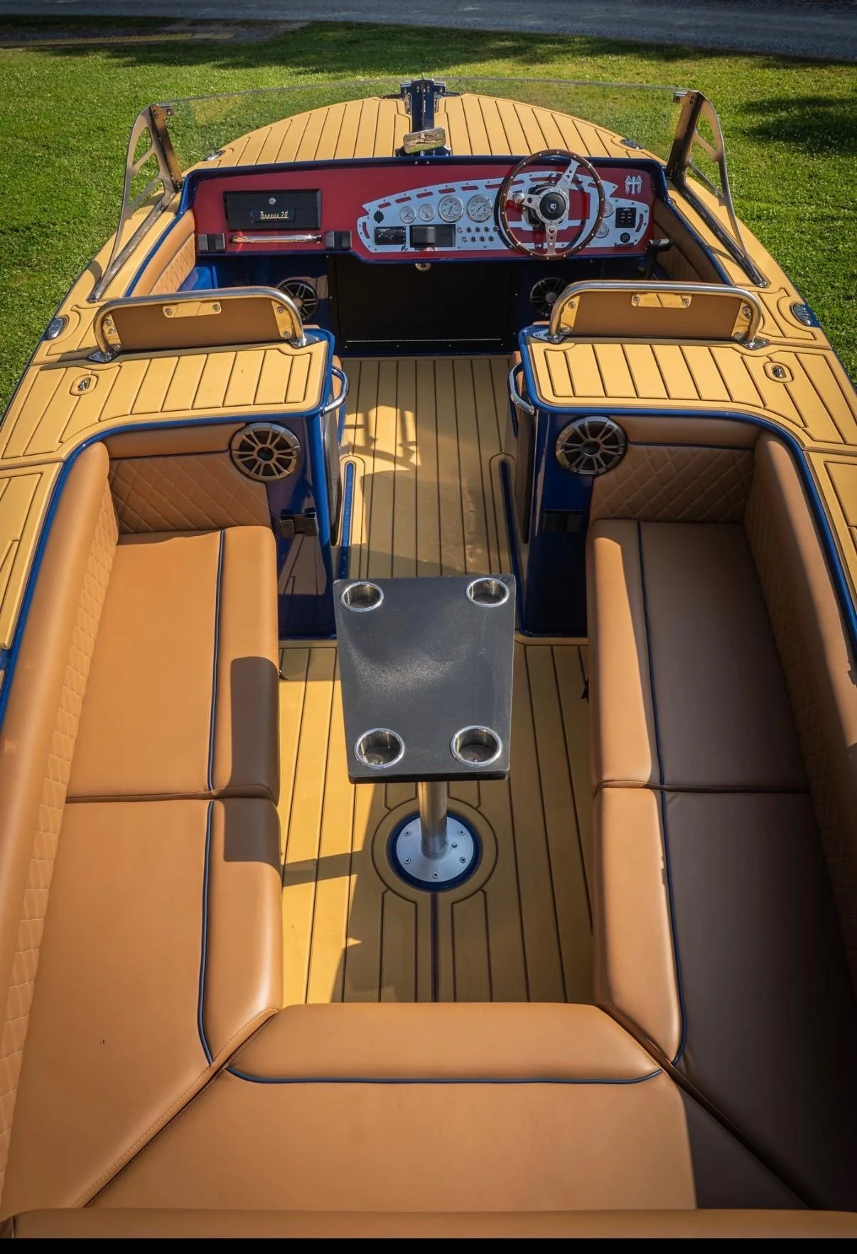 Tan deck panels fitted around the seating of a blue boat.