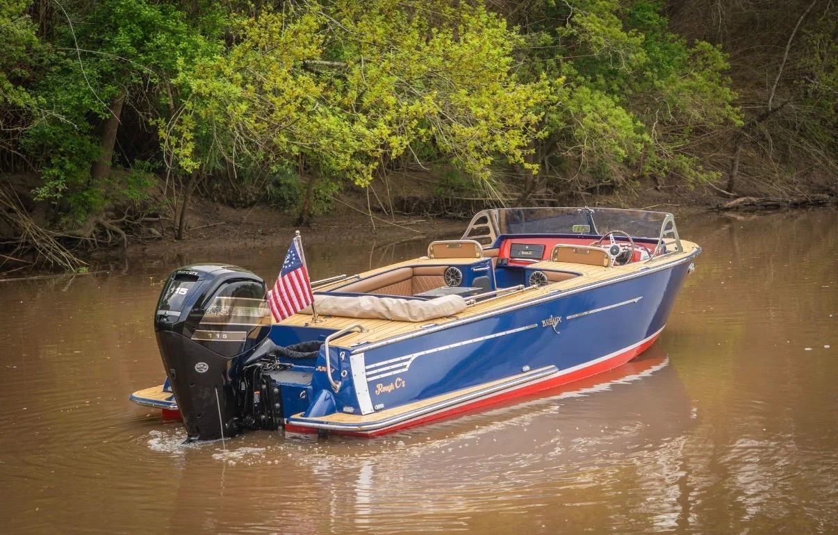 A blue boat on a wooded Louisiana waterway.