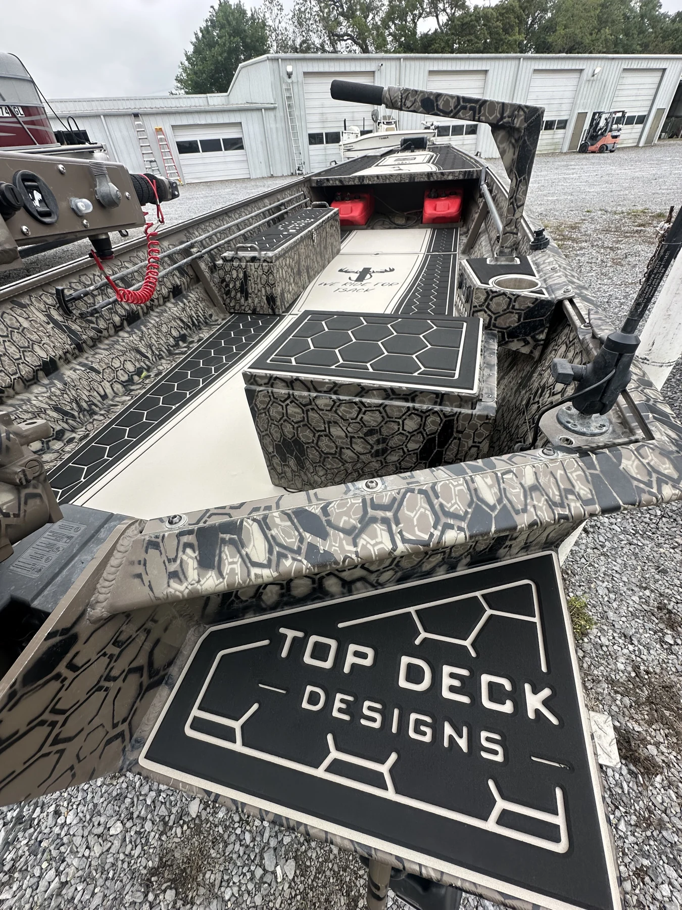Top Deck Designs logo integrated into a camouflage boat deck.