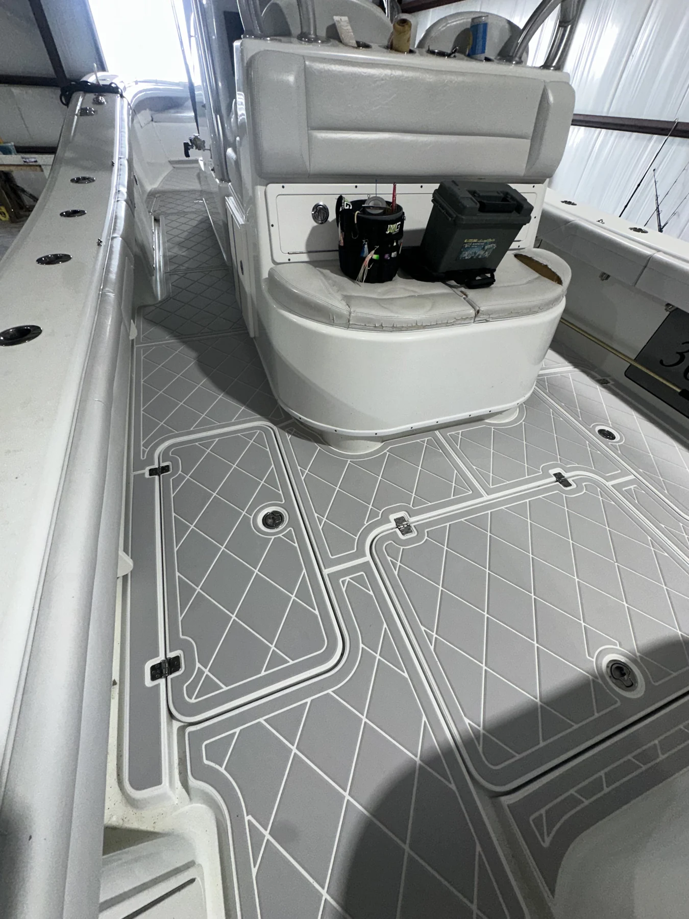 Light gray geometric flooring fitted around a fishing boat seat.