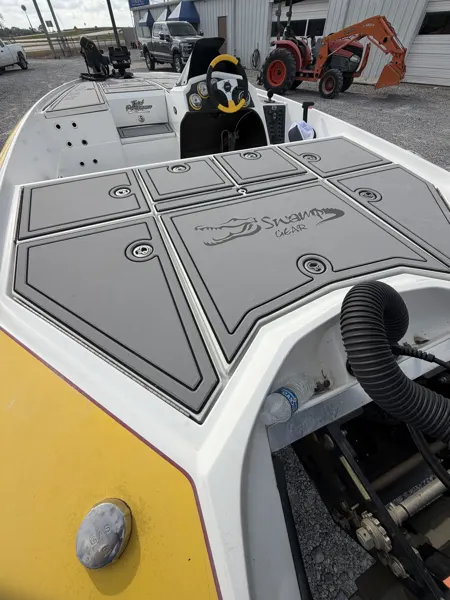 Gray patterned bow panels on a yellow fishing boat.