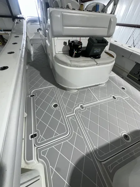 Light gray geometric flooring around a white boat seat base.