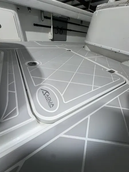 Light gray geometric flooring follows a seat base and hatch edges.